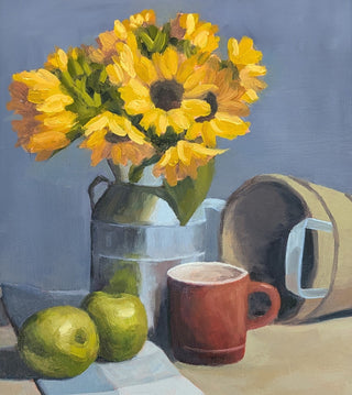 Framed still life painting featuring yellow sunflowers in a metal pitcher, green apples, a red mug, and a tipped-over bucket on a tabletop against a muted blue-gray background.